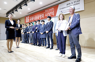 시상식에서 영광의 수상자들이 상장을 받으며 환하게 미소짓고 있다.